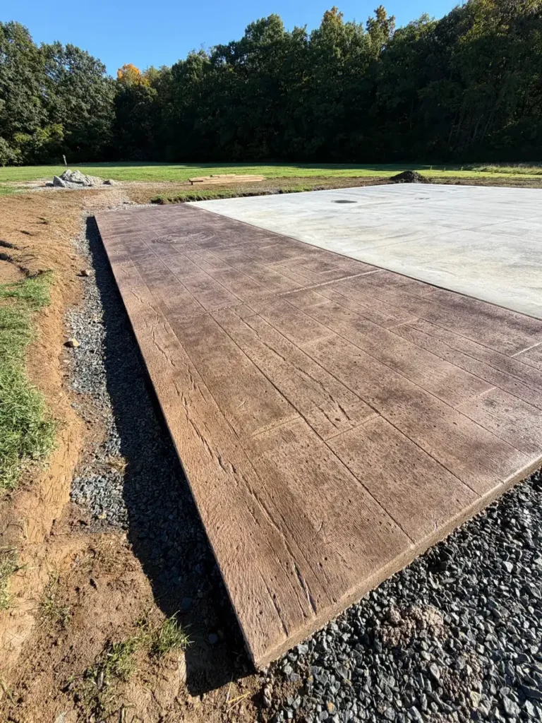 Wood plank stamped apron with broom finish concrete slab by Edges Unlimited in Clifton Park, NY