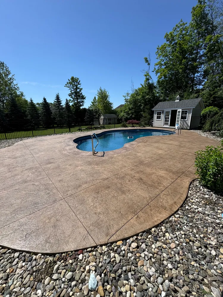 Tan stamped concrete pool deck by Edges Unlimited in Clifton Park, NY