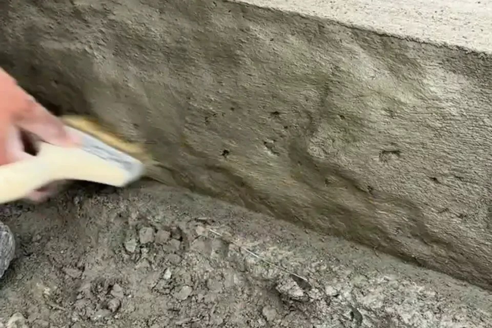Jeremy Hills hand finishing a chiseled step edge detail by Edges Unlimited in Clifton Park, NY