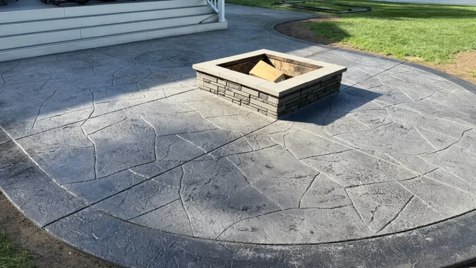 Stamped concrete patio with a fire pit by Edges Unlimited in Troy, NY